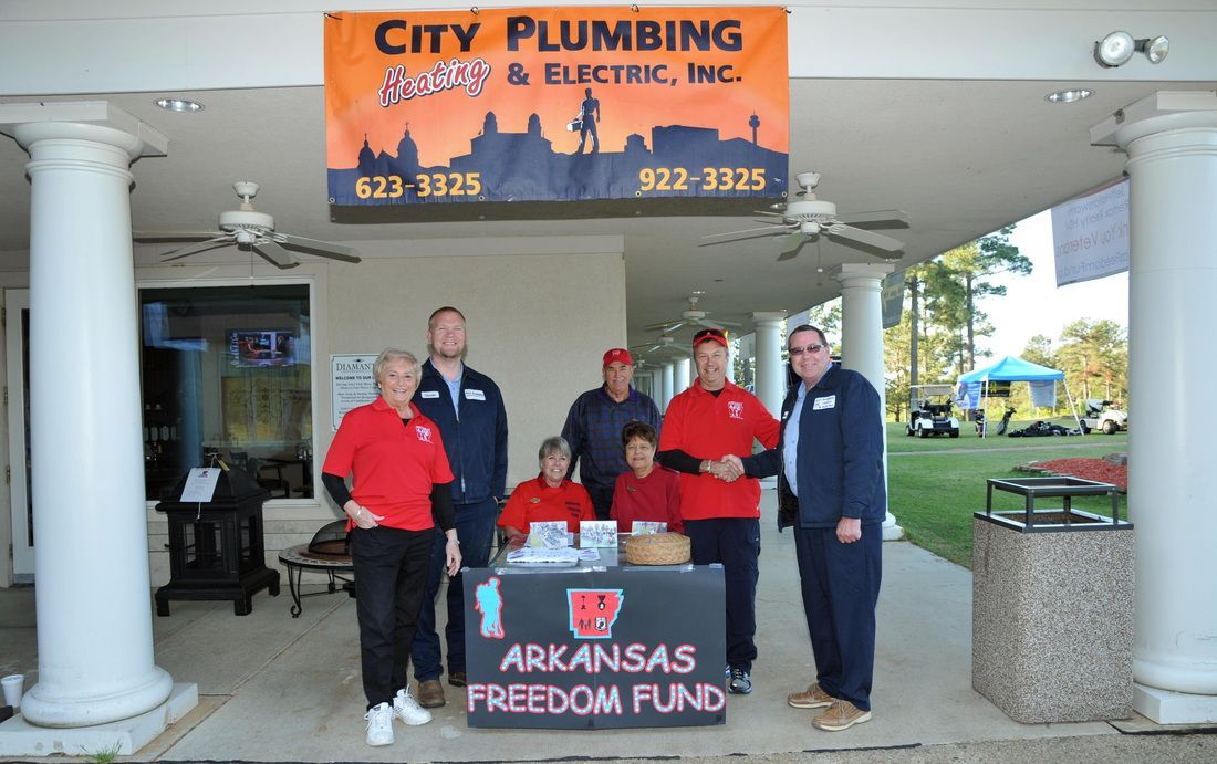 A group of people standing in front of a city plumbing sign