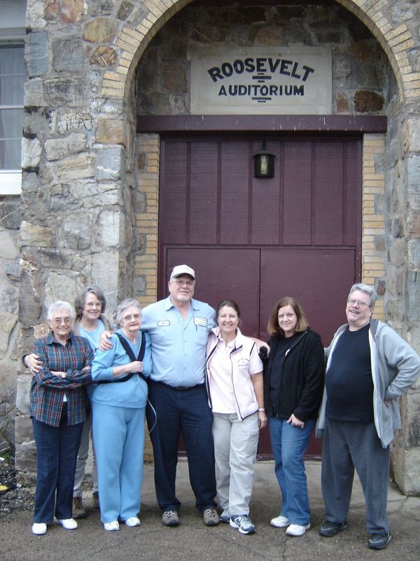 A group of people standing in front of the roosevelt auditorium