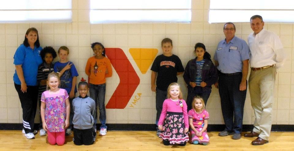 A group of people standing in front of a y logo