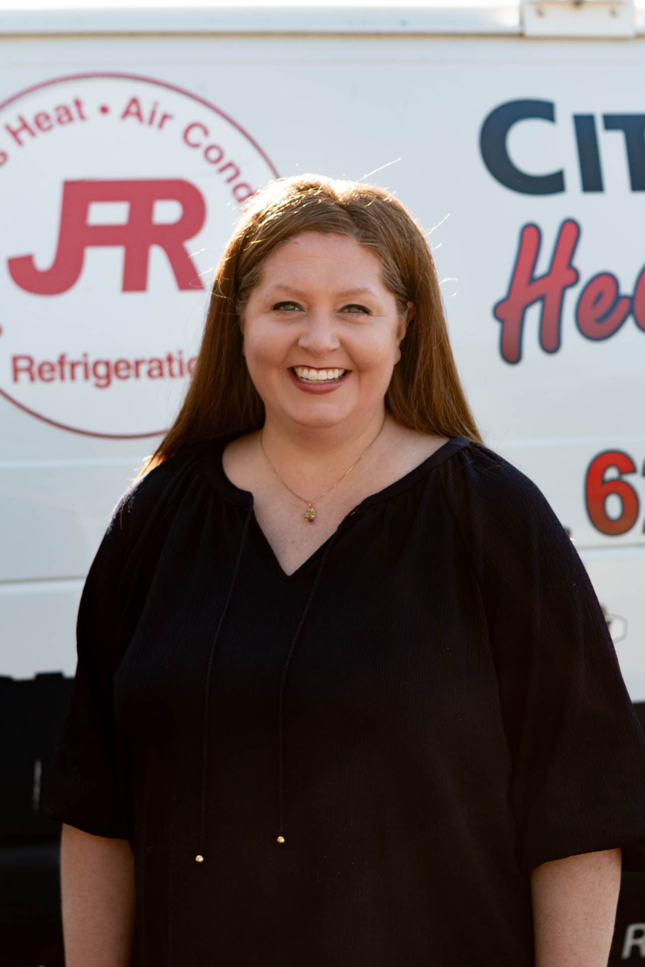 leslie standing in front of city plumbing van