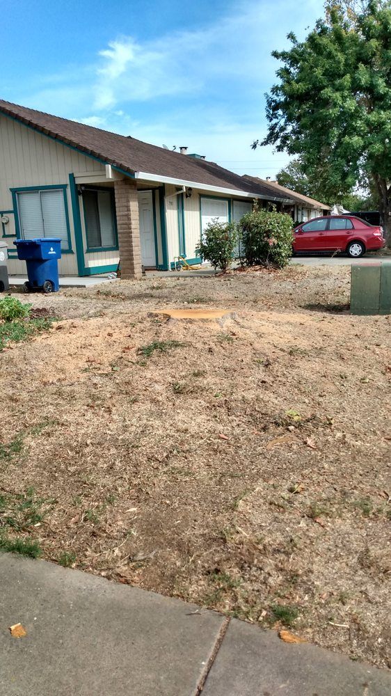 A house with a red car parked in front of it.