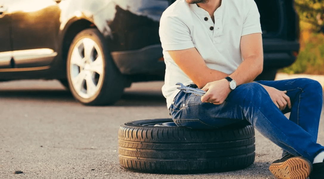 Man sitting on tyre - Advance Tyres