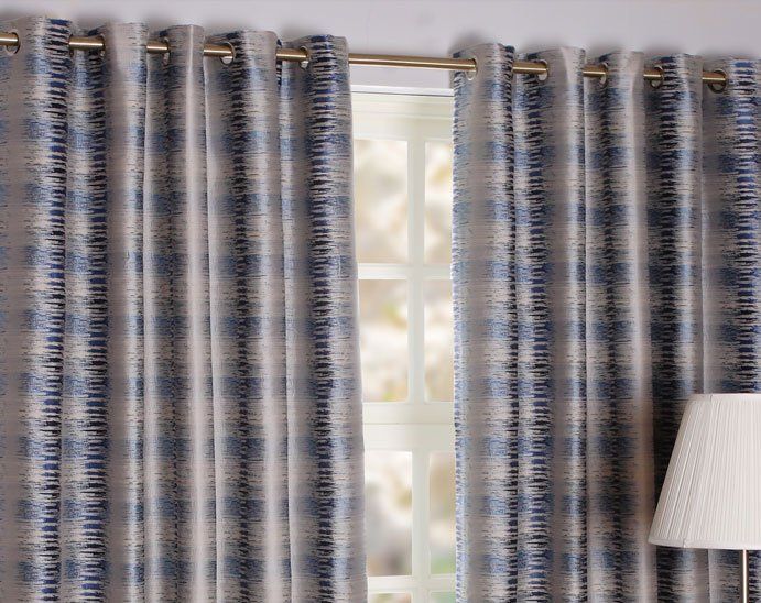 Grey striped curtains and a lamp