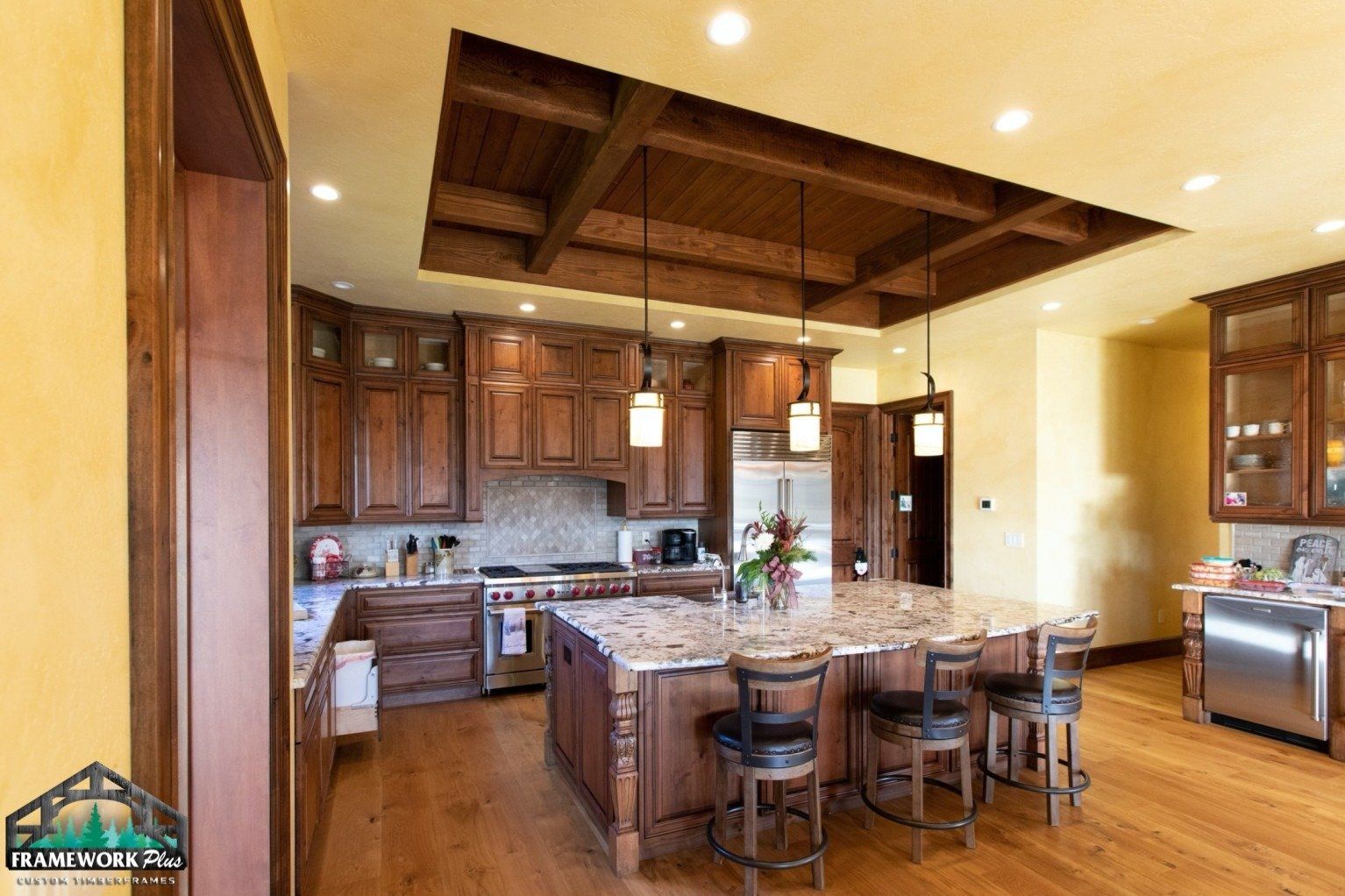 A kitchen with wooden cabinets and a large island
