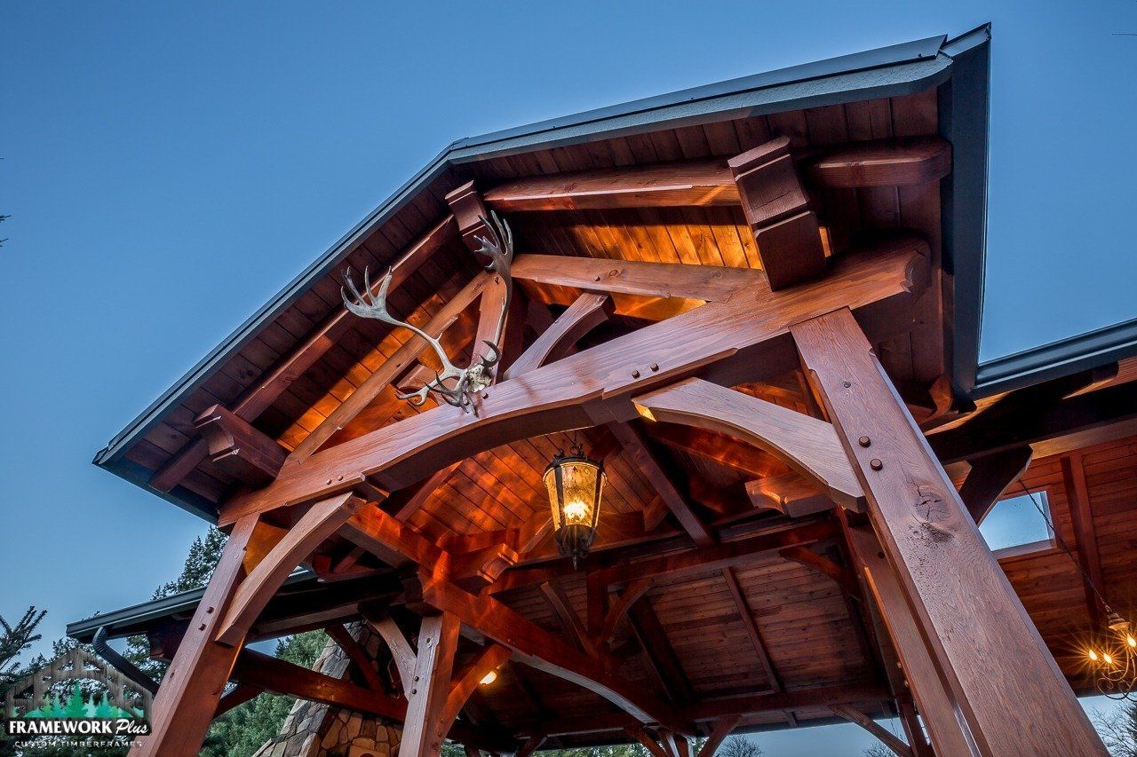 A wooden structure with a lantern and antlers on it.