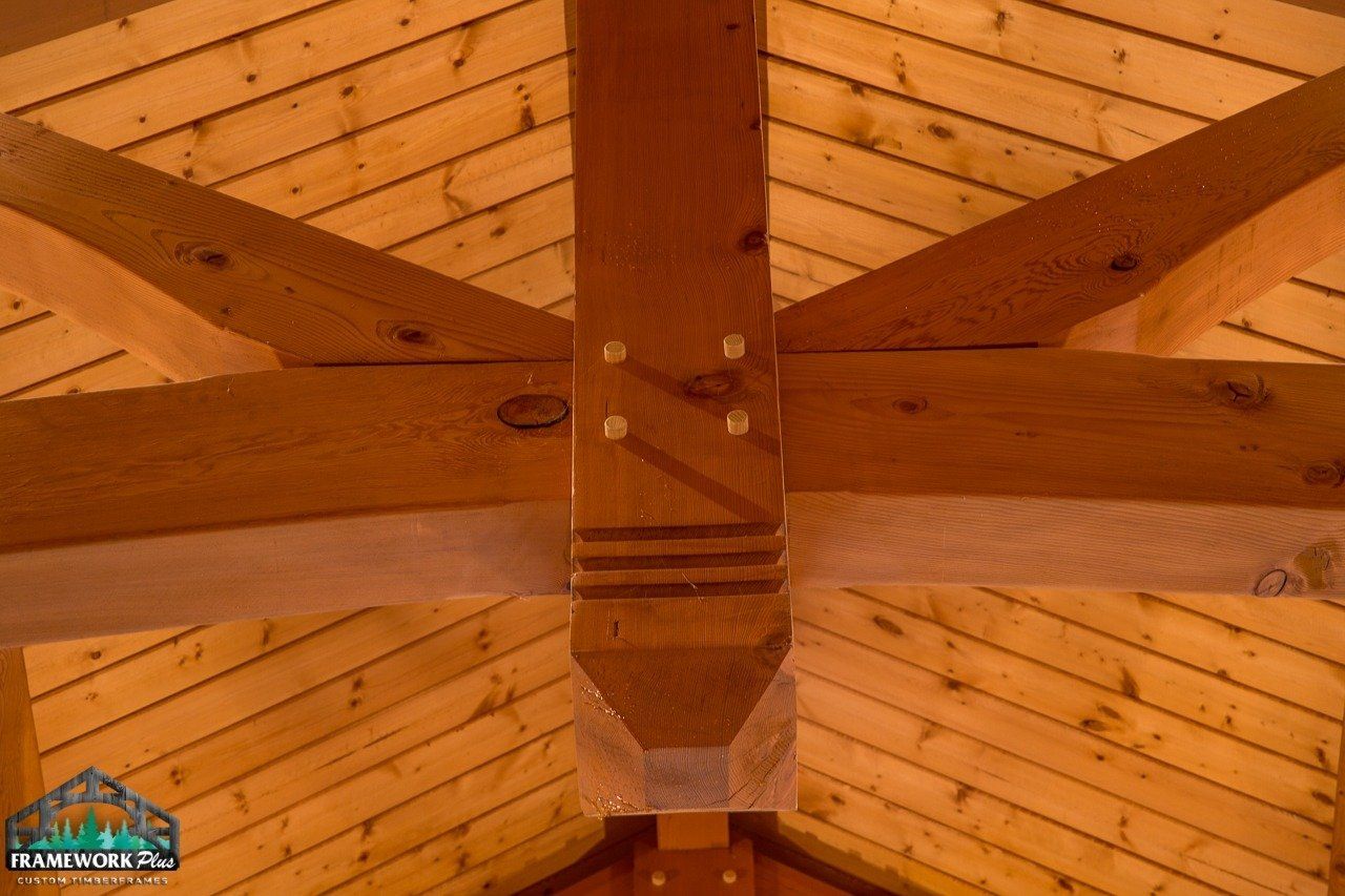 A picture of a wooden ceiling with a logo for timber hunters in the corner