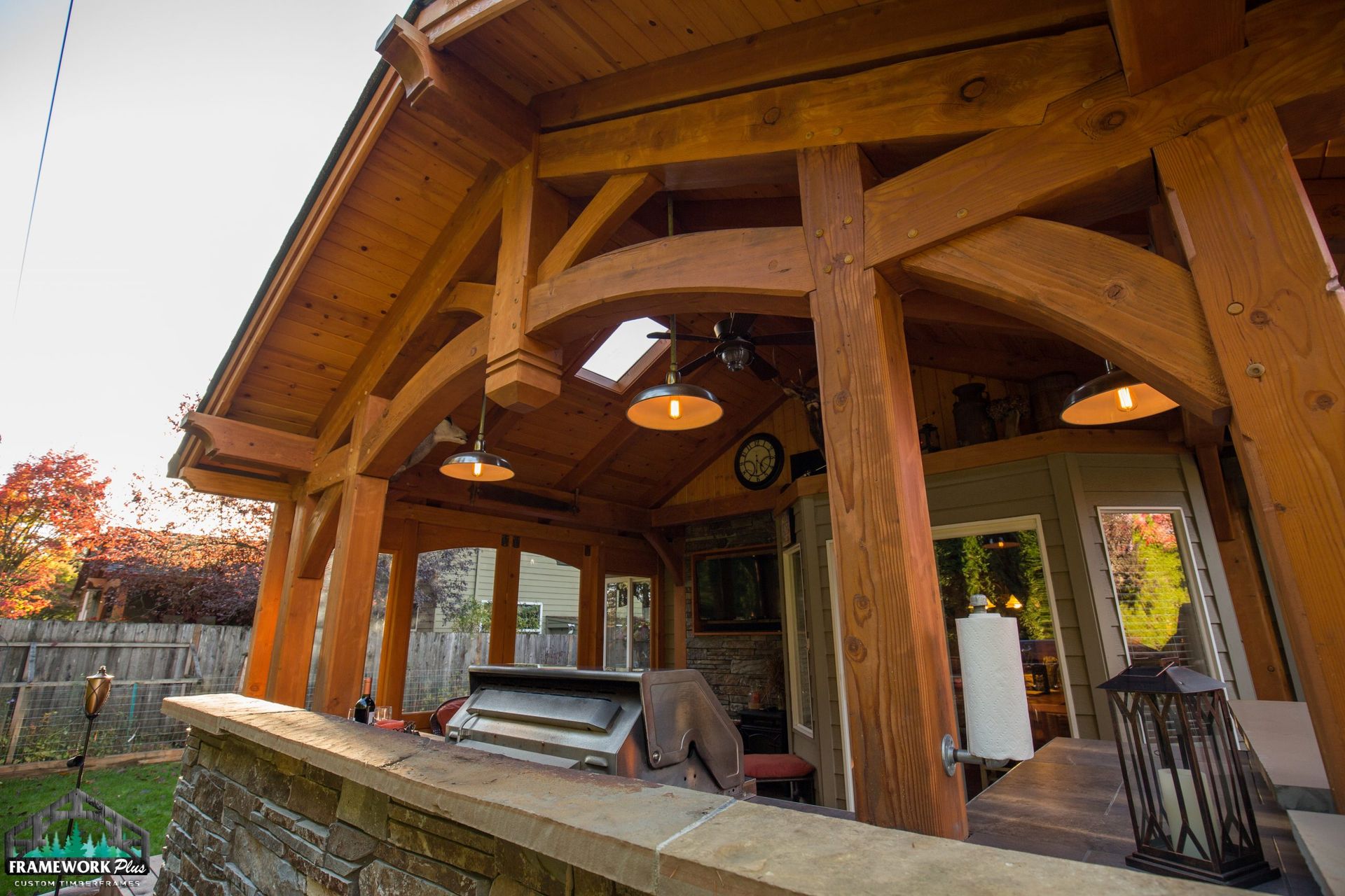 A wooden structure with a roof that has a skylight.