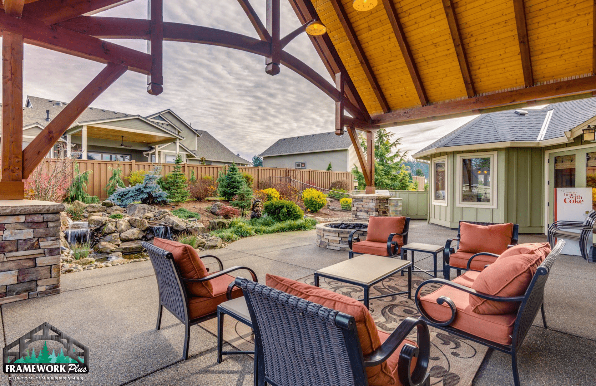 A patio with chairs and a table under a canopy.