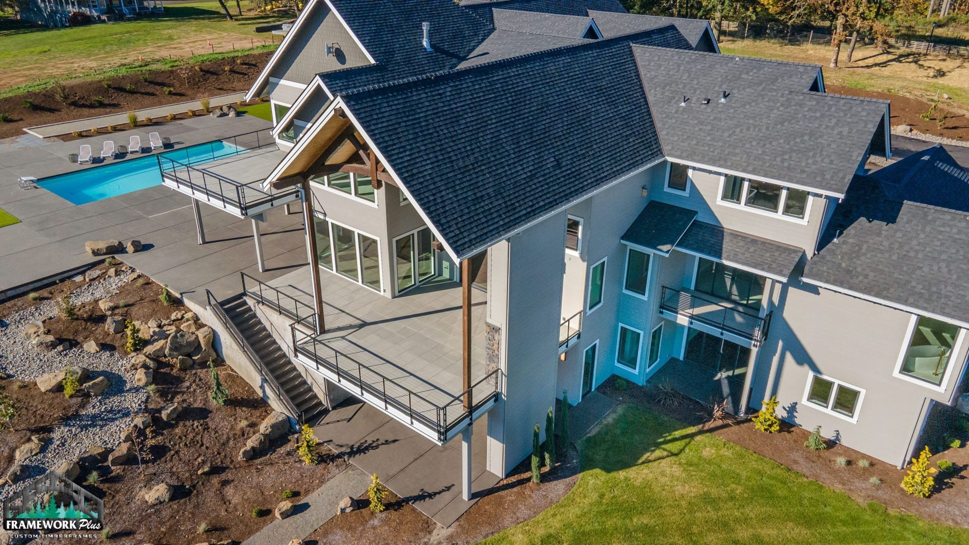 An aerial view of a large house with a pool in the backyard.