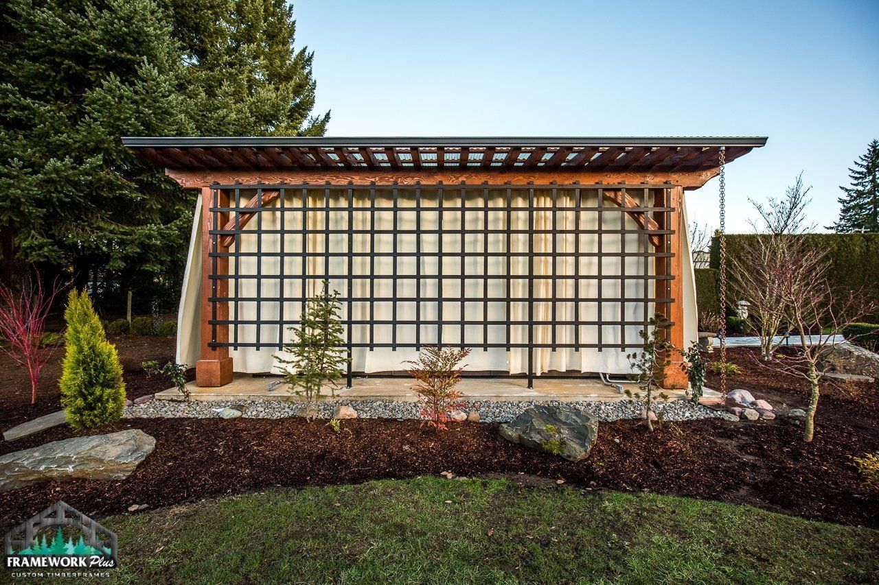 A wooden structure with a fence around it in a garden.