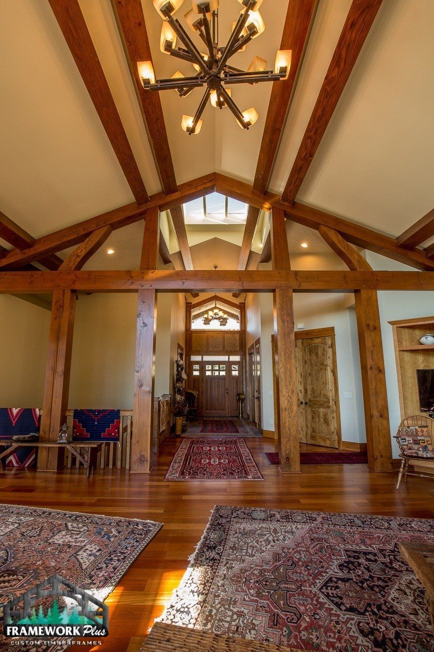 A living room with a vaulted ceiling and a chandelier