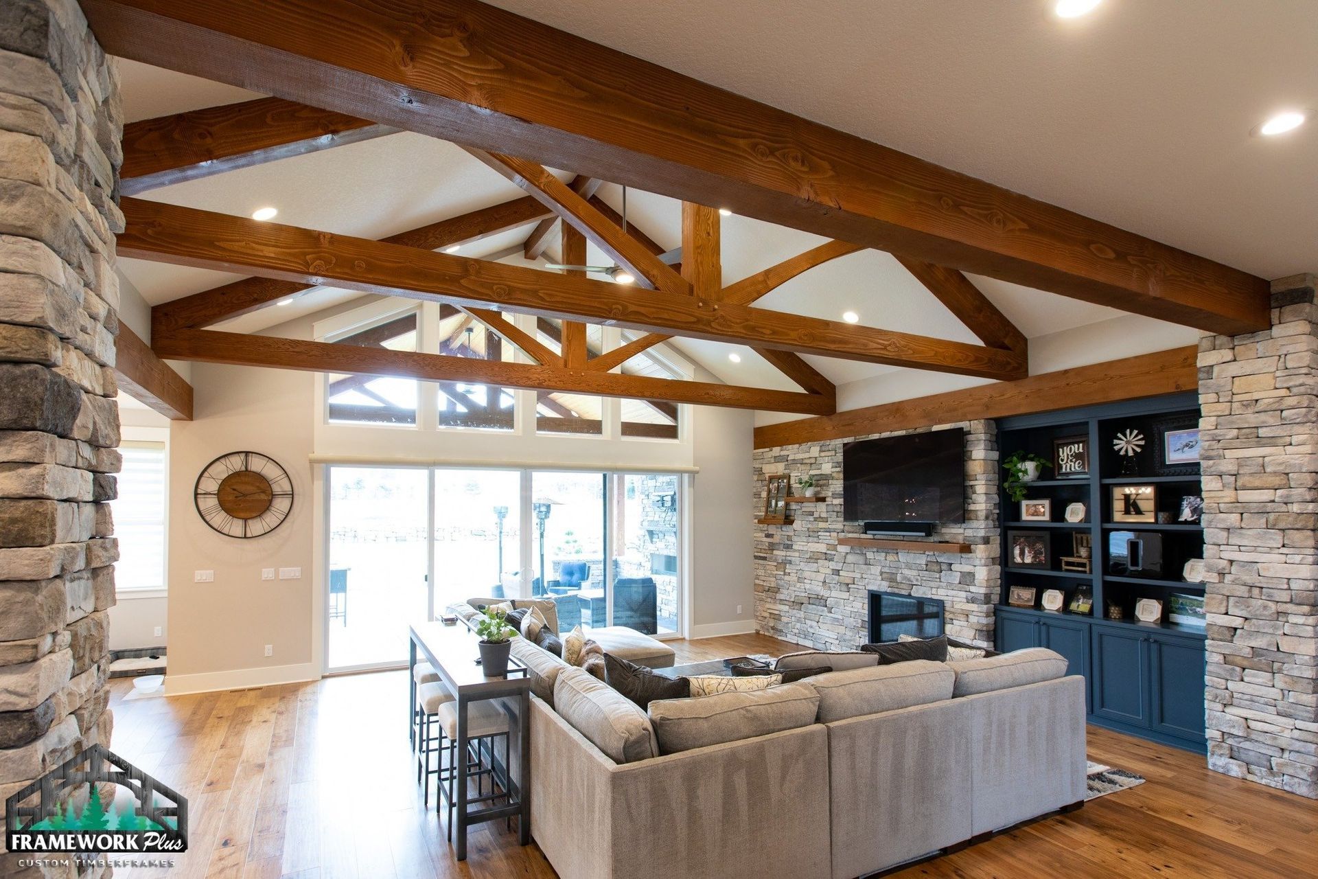 A living room with a couch and a television on the wall.