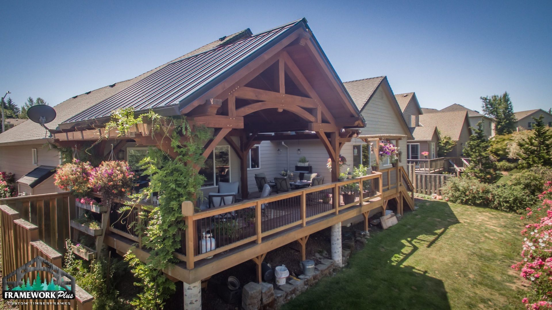 An aerial view of a house with a large wooden deck