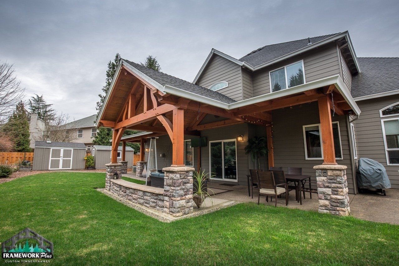A large house with a large covered patio in front of it.