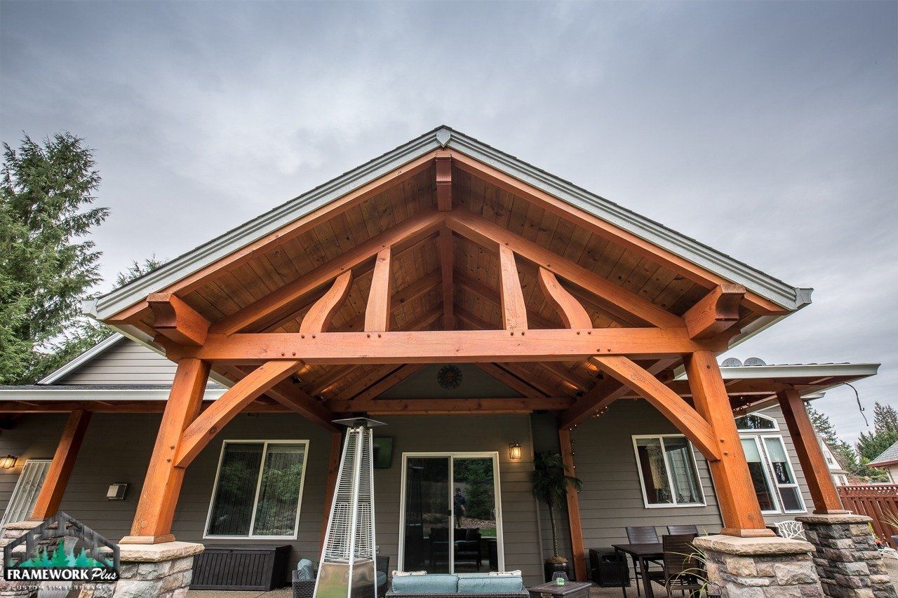 A house with a wooden roof and a wooden porch.