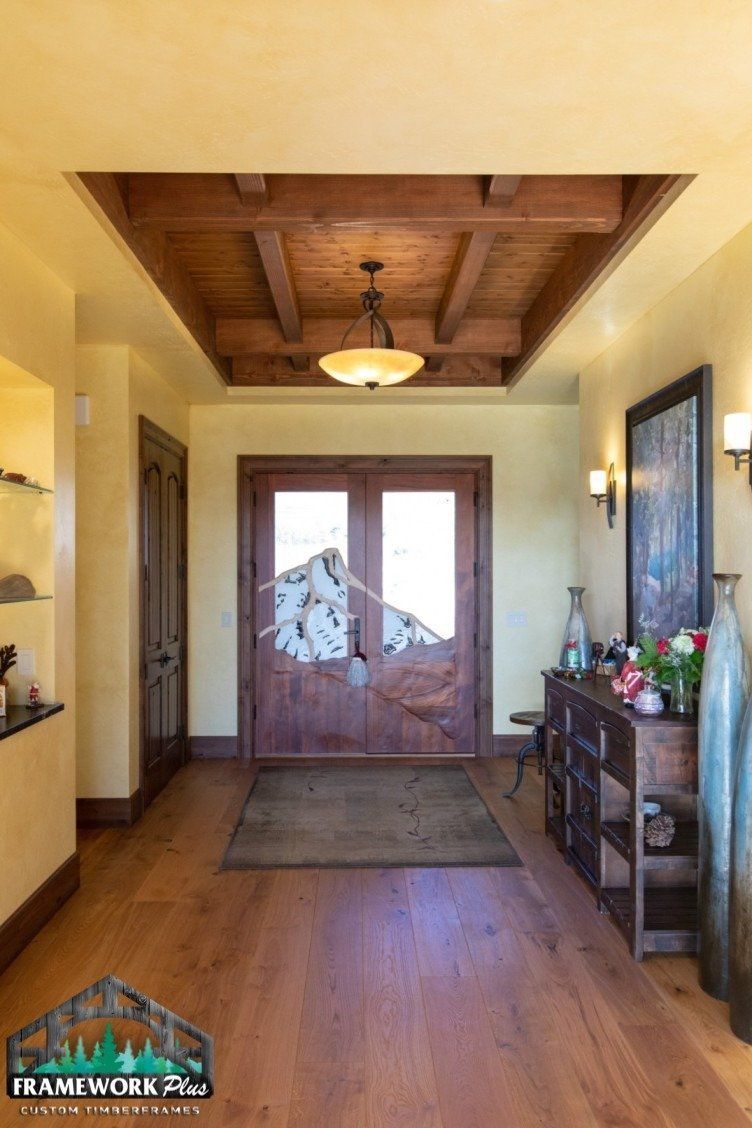 A hallway with hardwood floors and a wooden ceiling