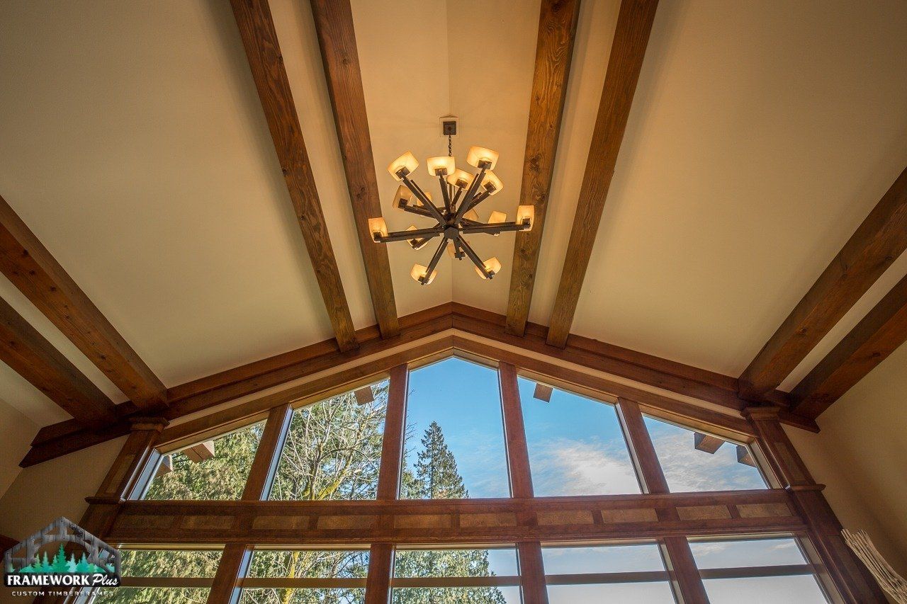 A large window with a chandelier hanging from the ceiling.