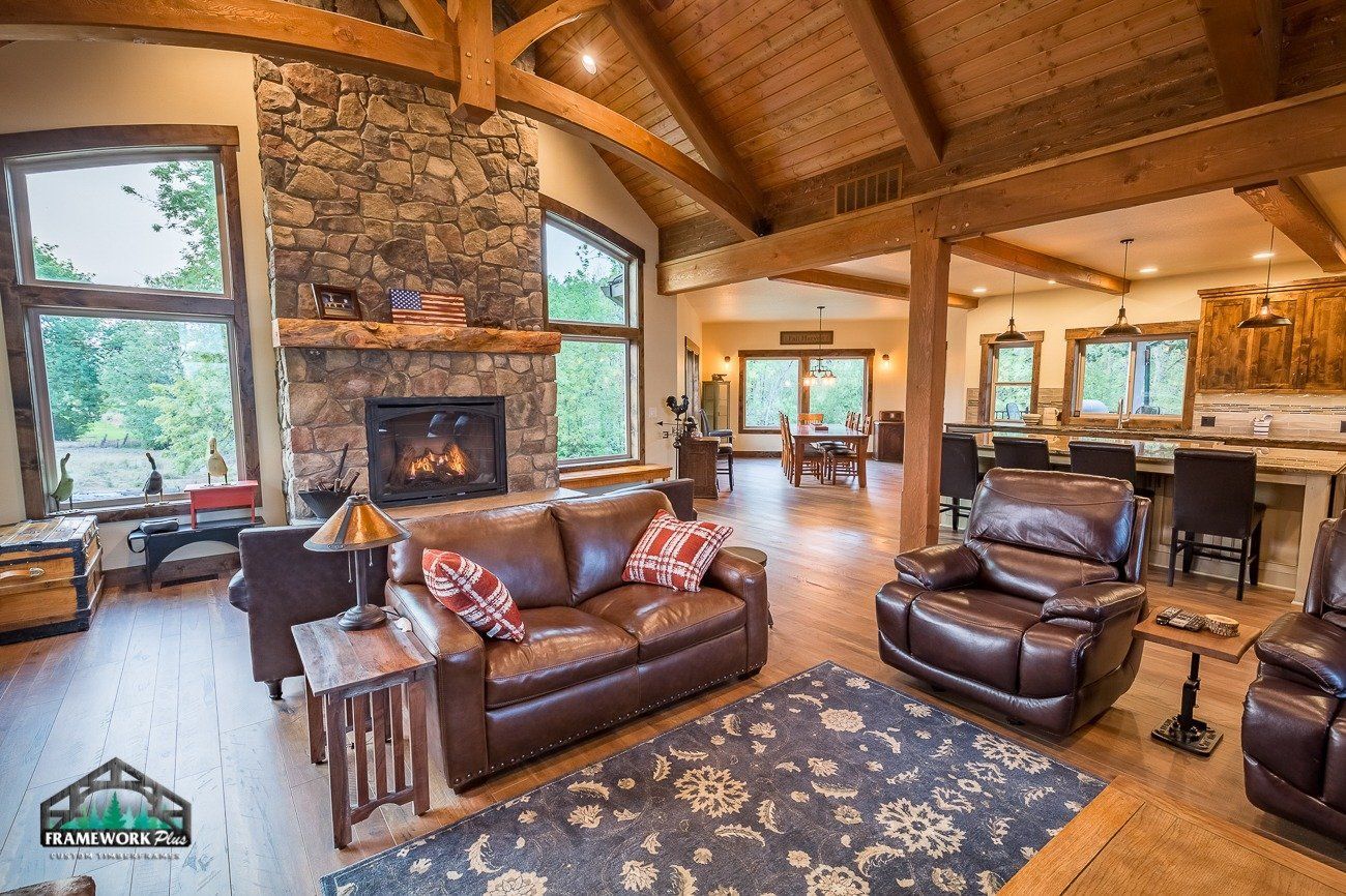 A living room with a couch , chairs , and a fireplace.
