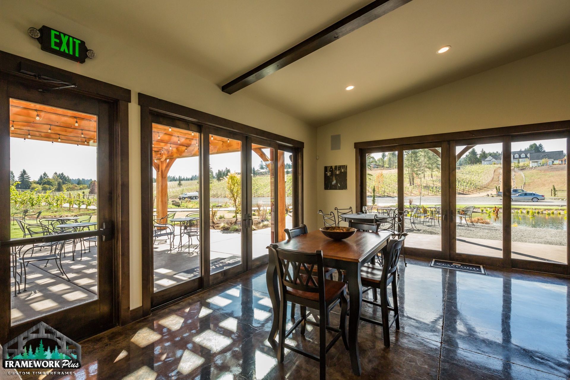 A large room with lots of windows and an exit sign
