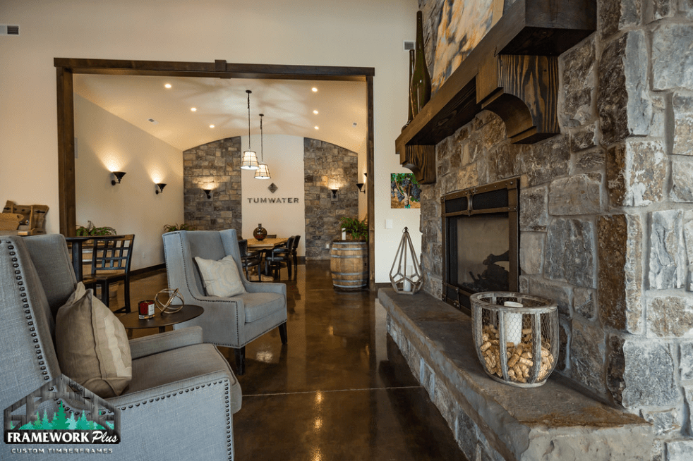 A living room with a fireplace , chairs and a table.