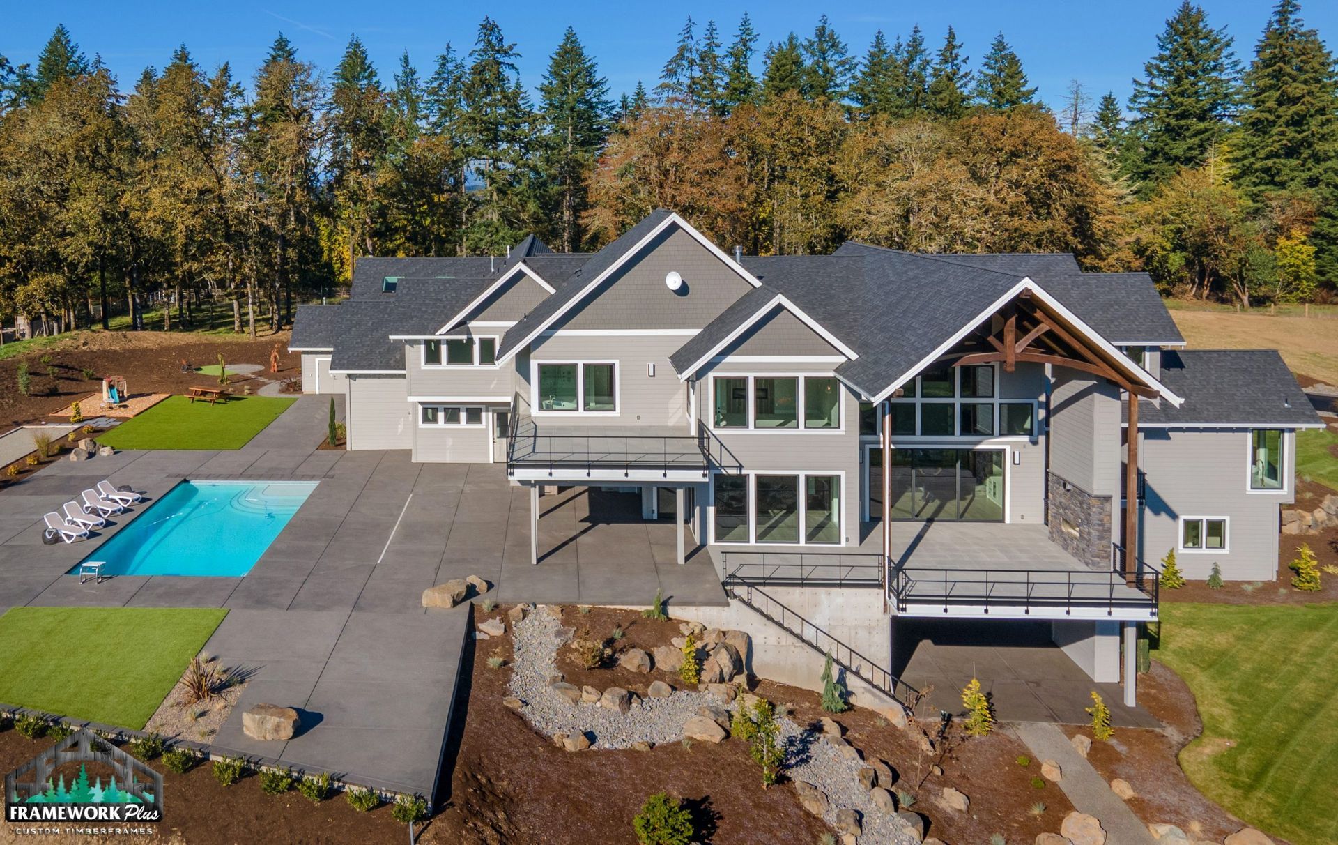 An aerial view of a large house with a swimming pool