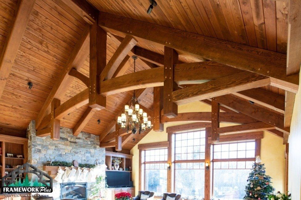 A living room with wooden beams and a christmas tree