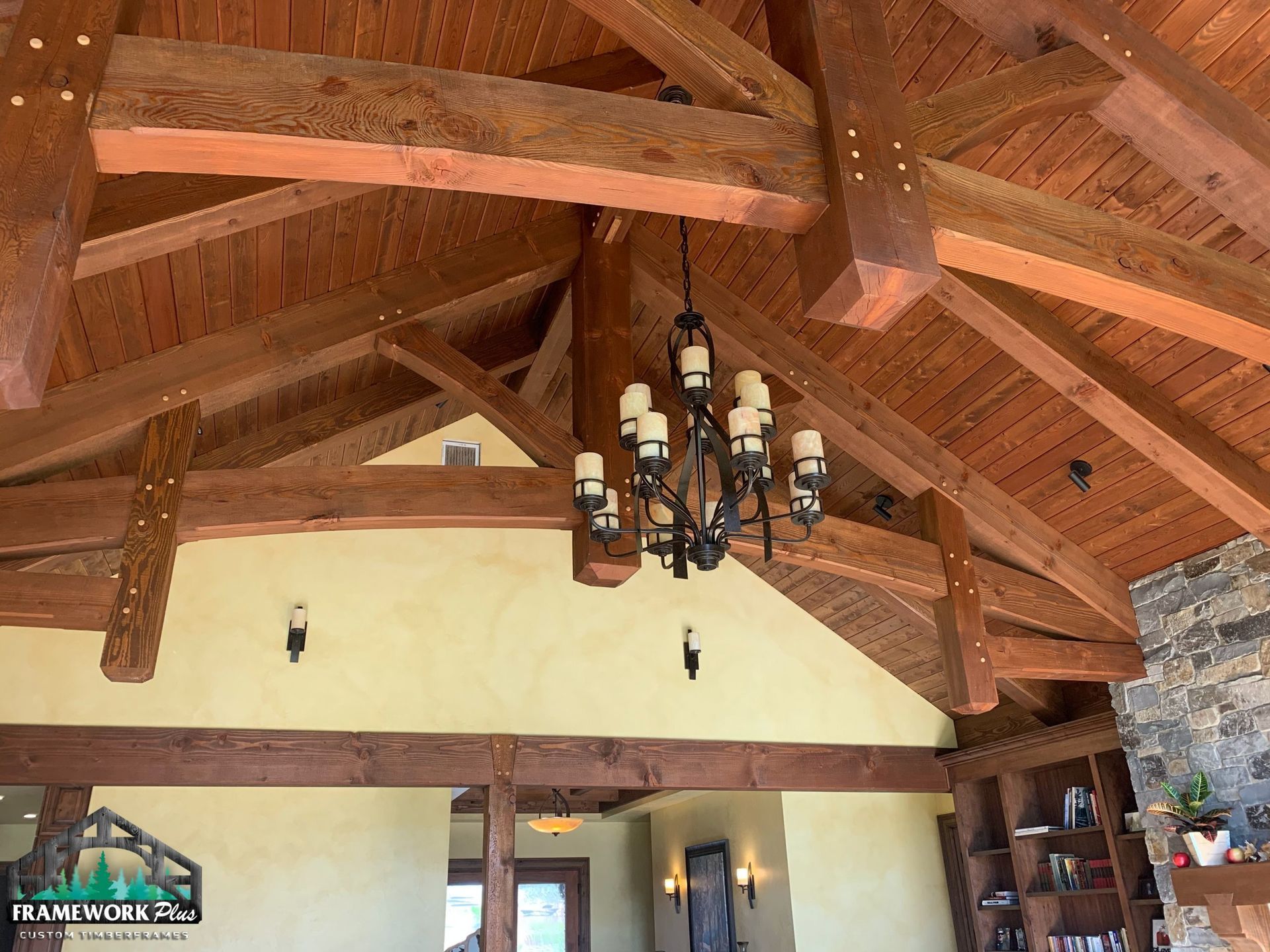 A wooden ceiling with a chandelier hanging from it
