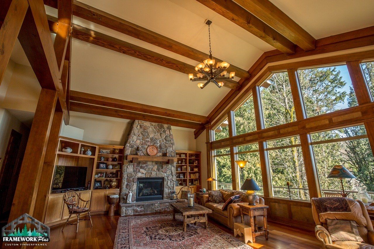 A living room with a fireplace and lots of windows