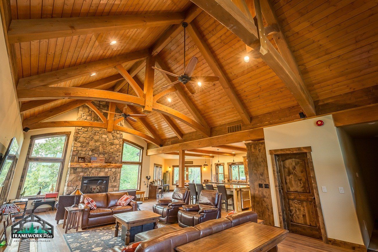 A living room with a vaulted ceiling and a fireplace.