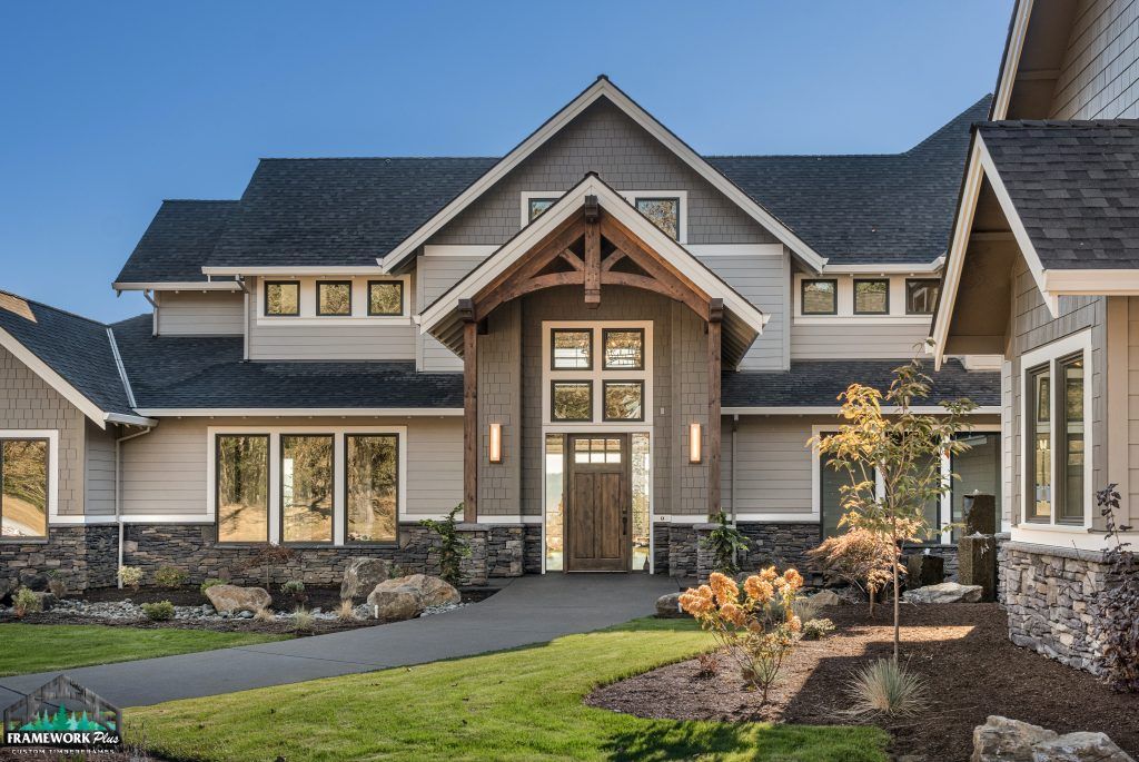 A large house with a lot of windows and a black roof