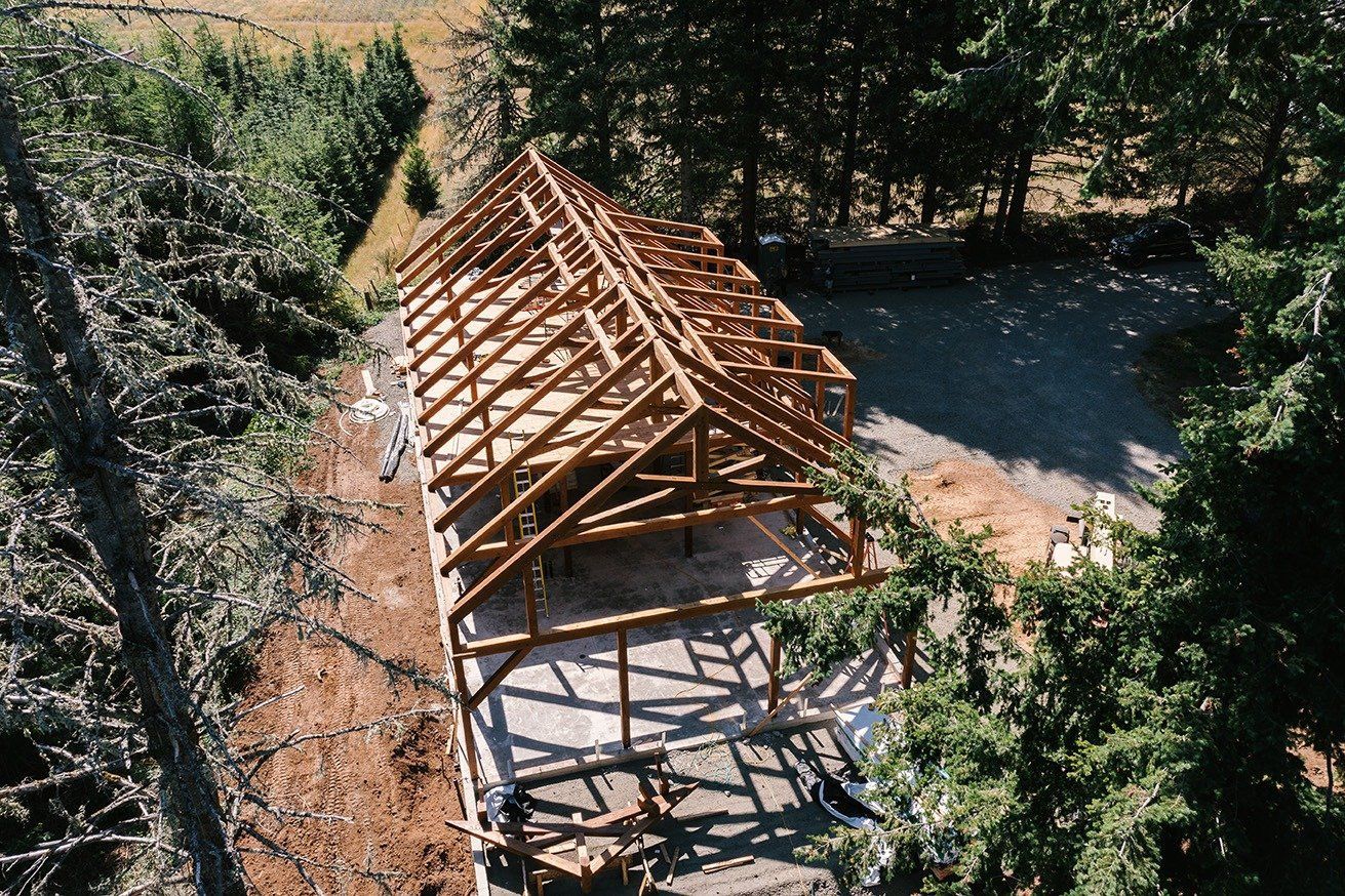 An aerial view of a wooden structure in the middle of a forest