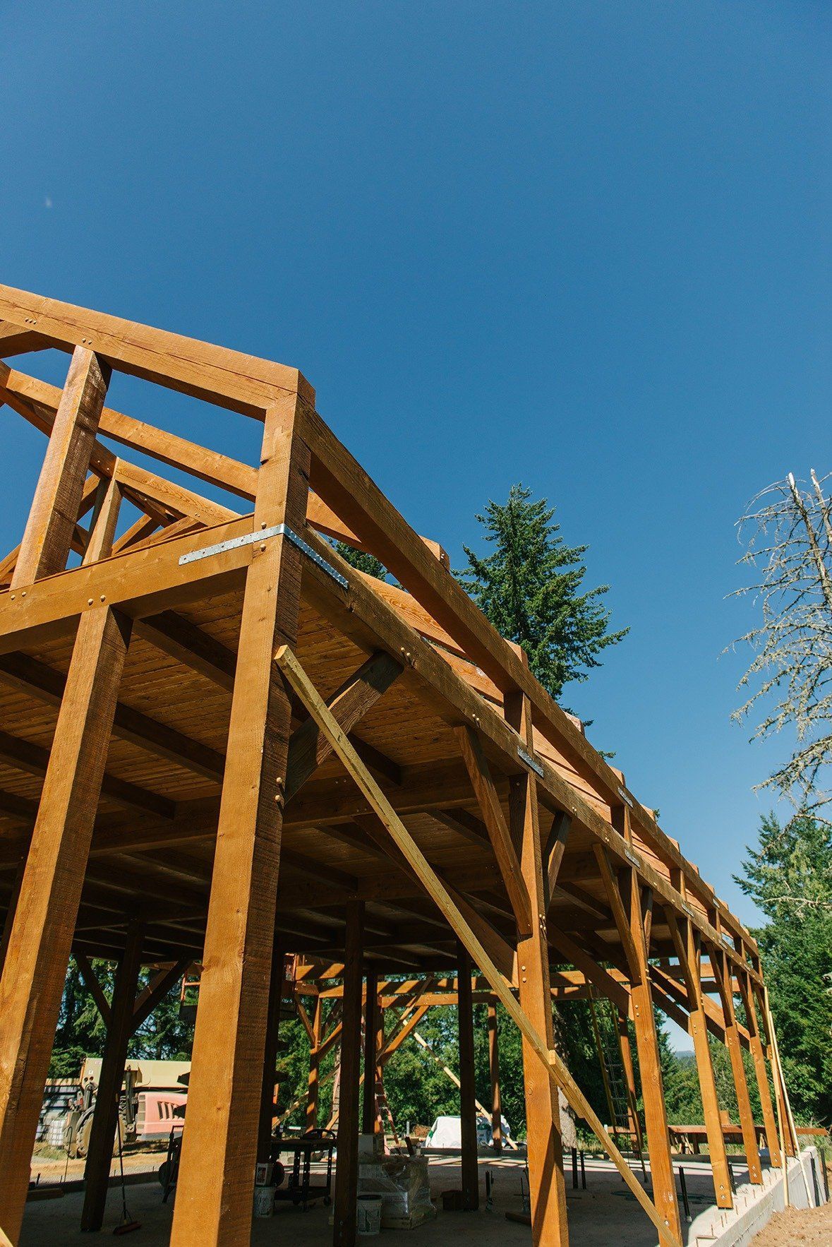A wooden structure is being built with a blue sky in the background.