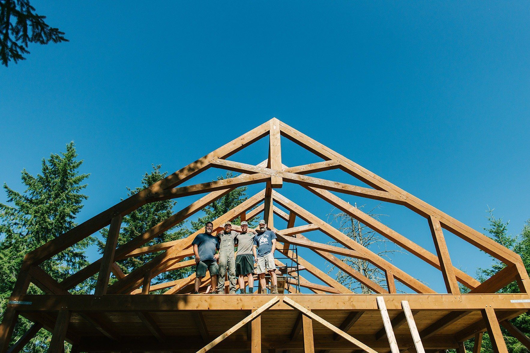 A group of people are standing on top of a wooden structure.