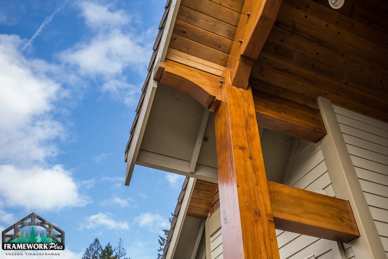 A close up of a wooden post on the side of a house.