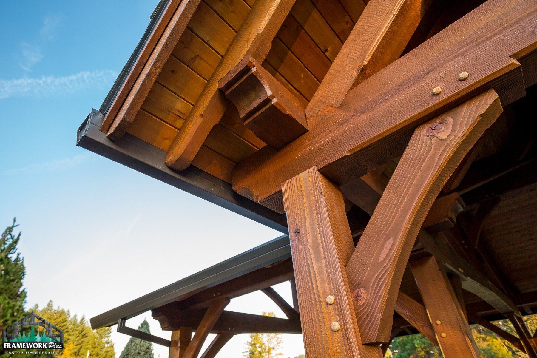 A close up of a wooden structure with a blue sky in the background.