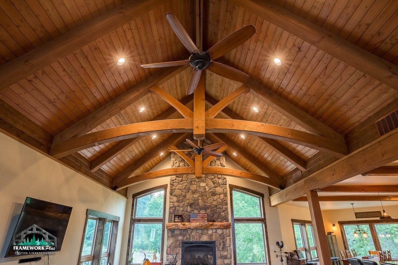 A living room with a ceiling fan and a fireplace.