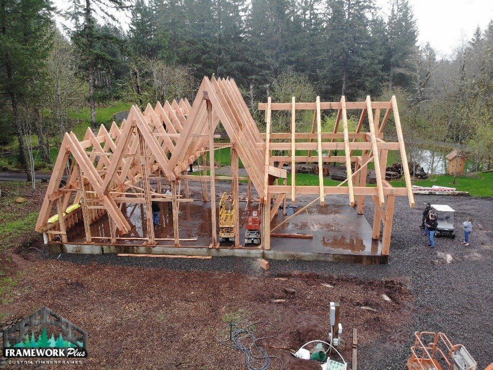 An aerial view of a wooden house under construction.