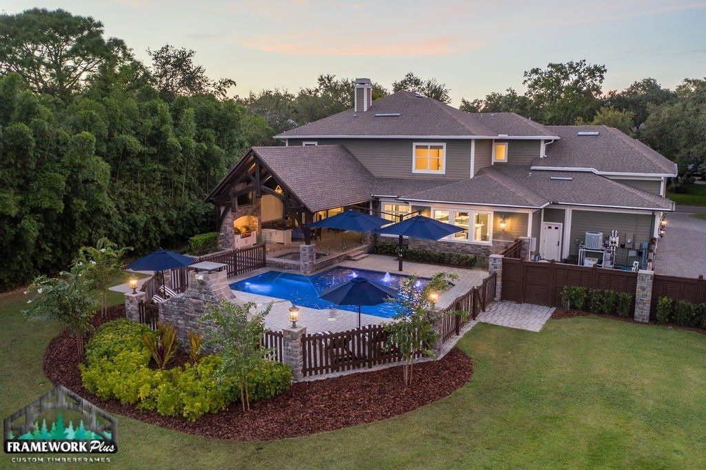 An aerial view of a large house with a swimming pool