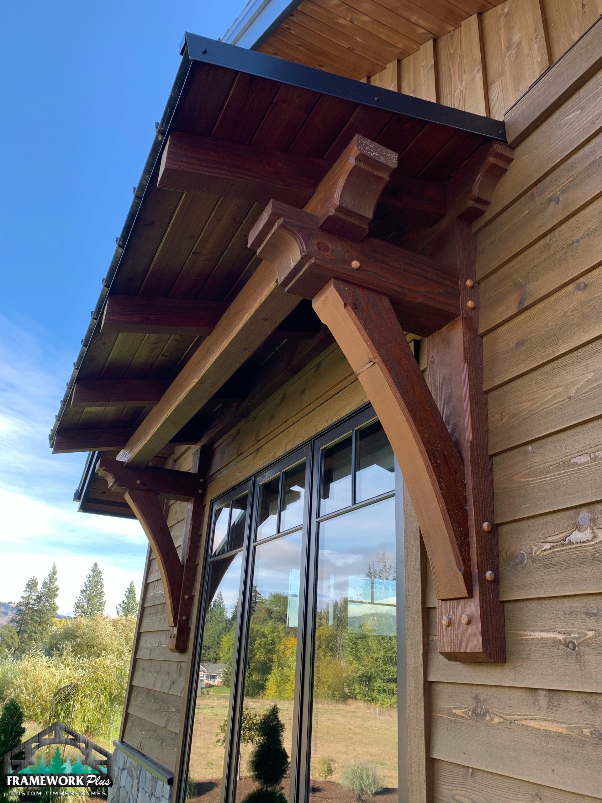 A wooden canopy is attached to the side of a building.