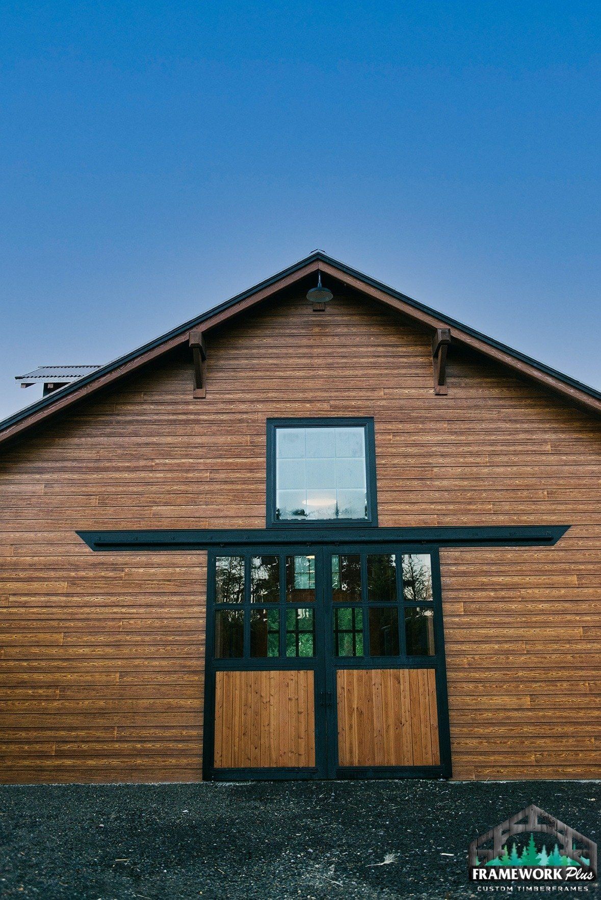 A wooden barn with a sliding door and a window.