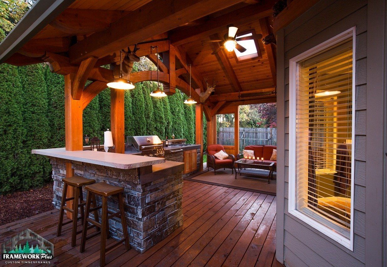 A wooden deck with a bar and a ceiling fan