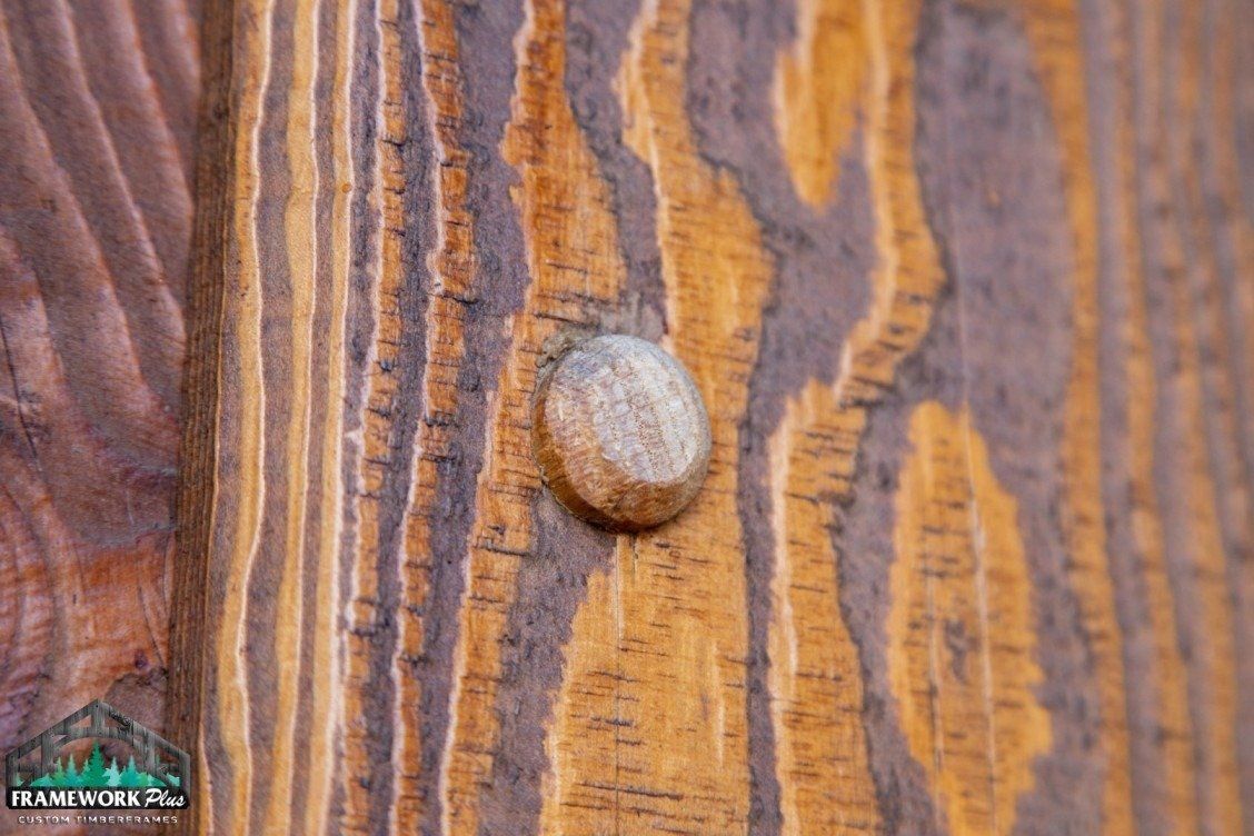 A small rock is sitting on a piece of wood.
