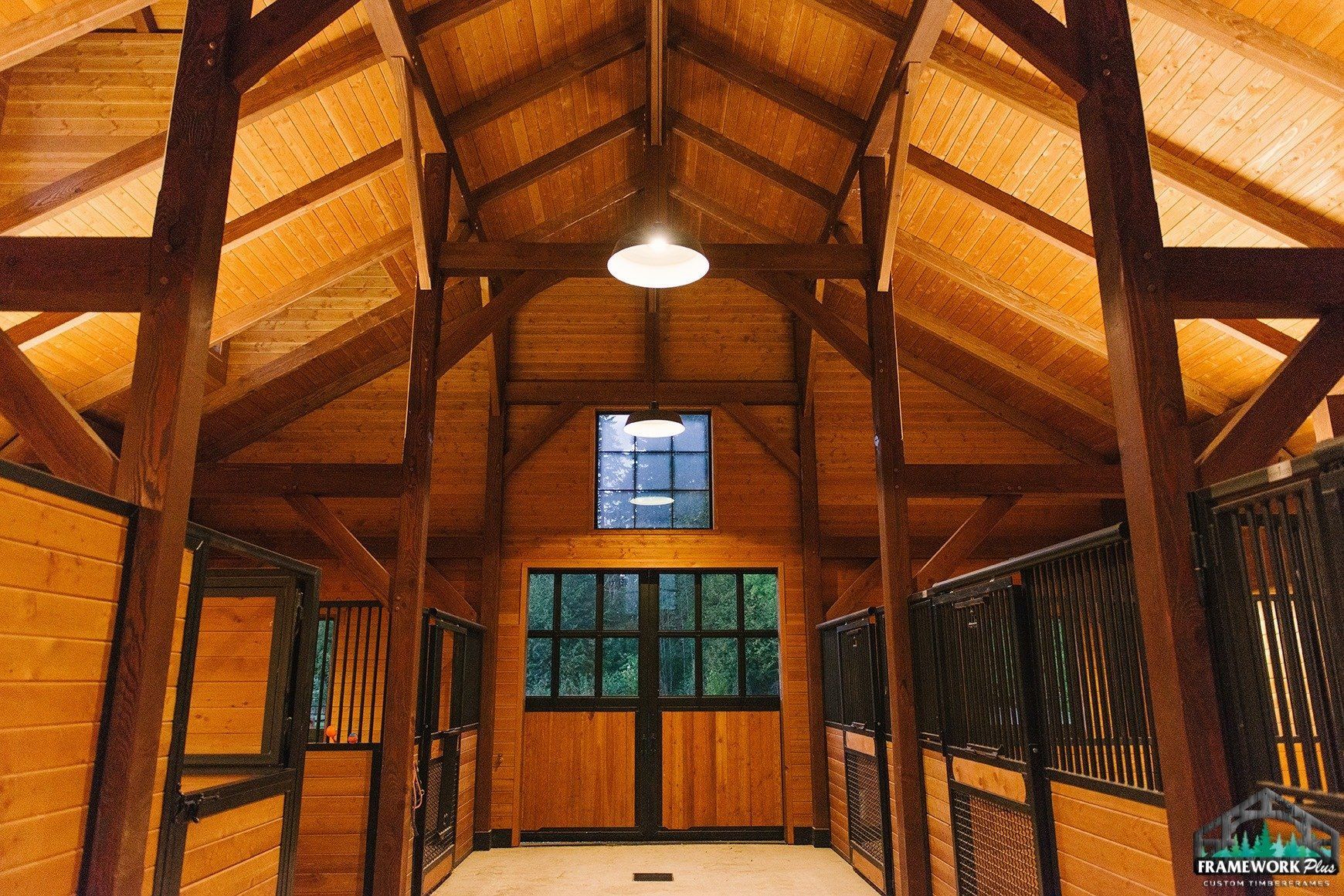 The inside of a wooden barn with a ceiling and a window.