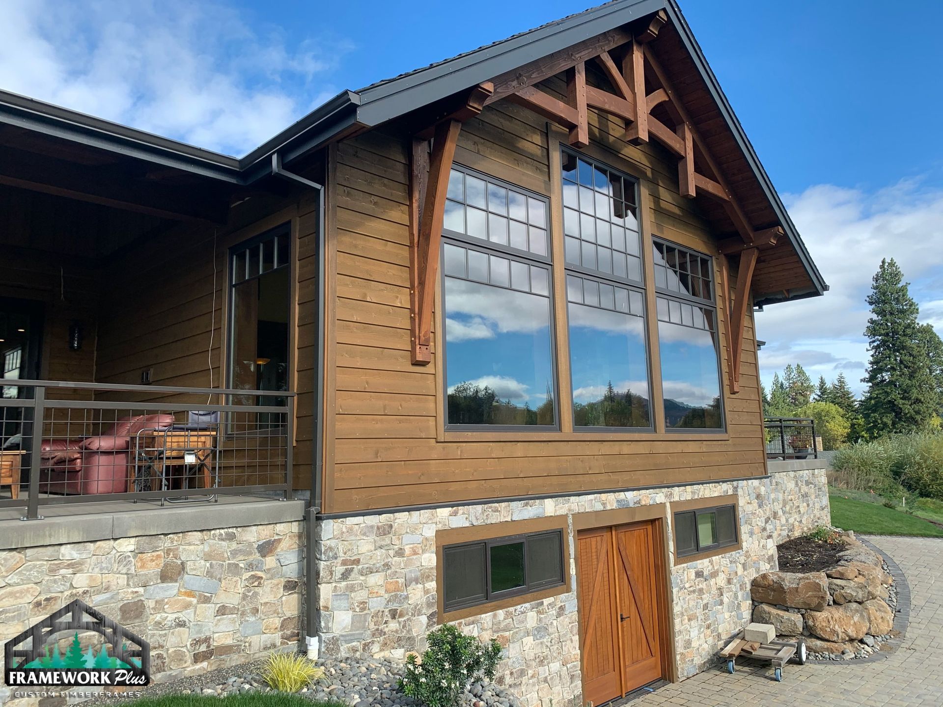 A large house with a lot of windows and a stone wall