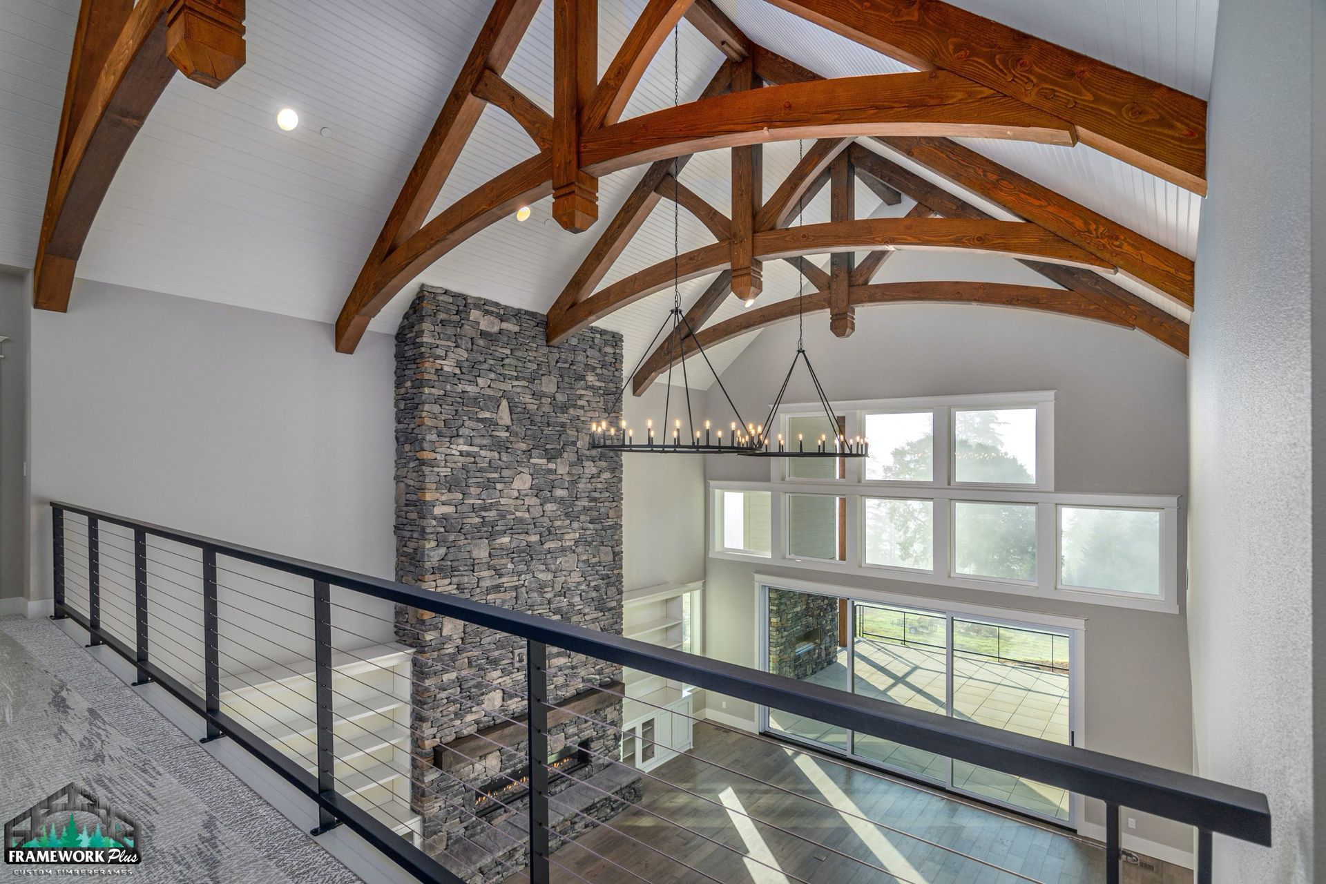 A living room with a fireplace and wooden beams.