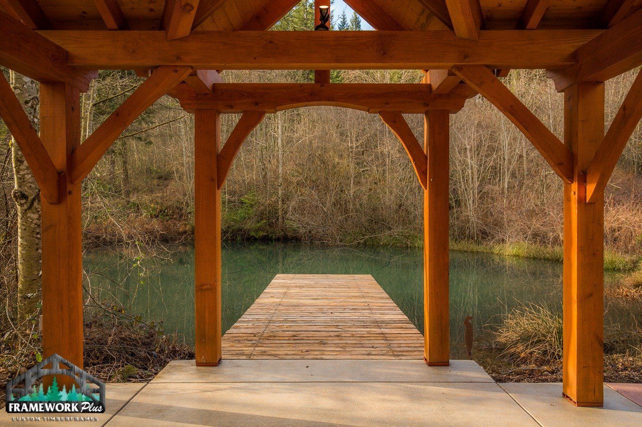 A wooden structure with a dock leading to a lake.