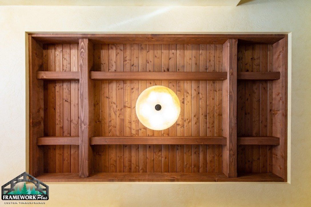 A wooden ceiling with shelves and a light on it.