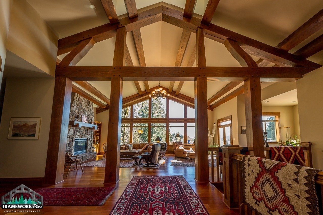 A large living room with a vaulted ceiling and wooden beams.