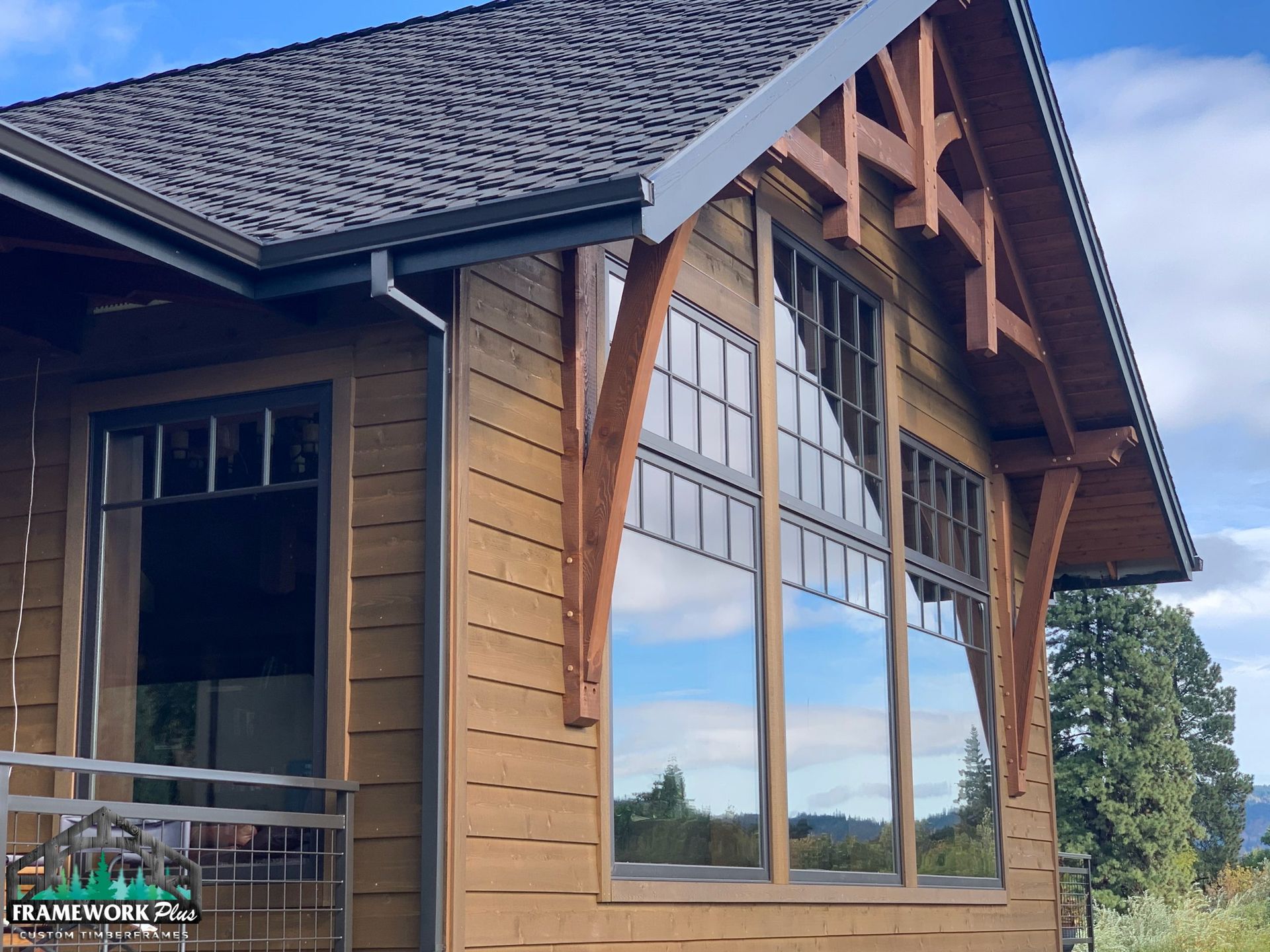 A wooden house with a roof and a lot of windows