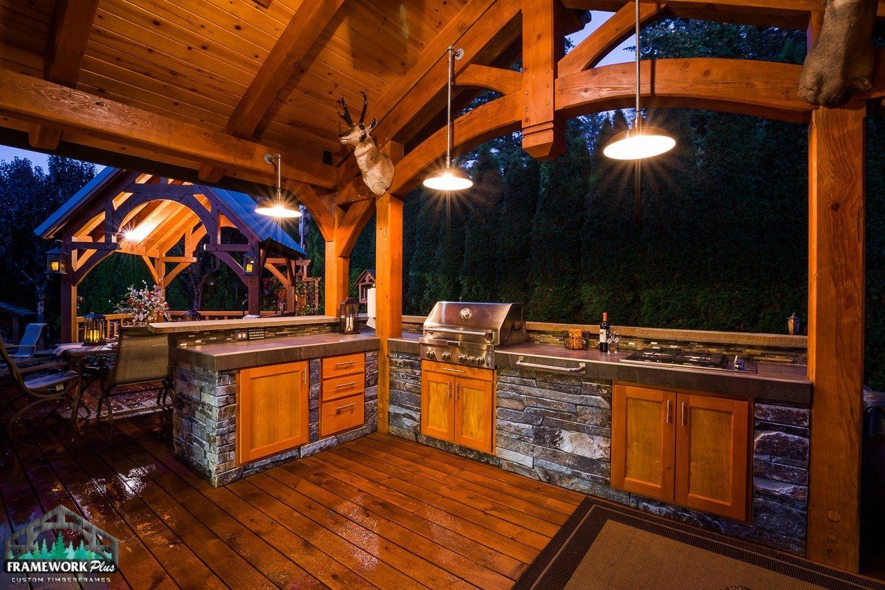 An outdoor kitchen with a deer head on the ceiling
